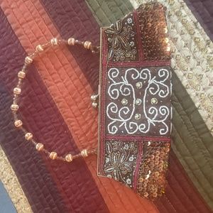 Beaded sequined clutch w hide and seek handle, goldtone snap closure/frame.